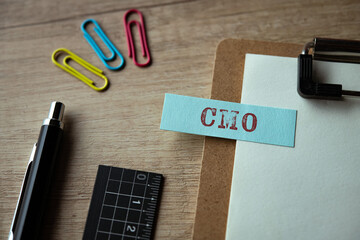 There is sticky note with the word CMO. It is an abbreviation for Chief Marketing Officer as eye-catching image.