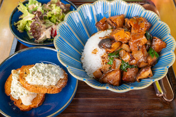 angle view beef cubes with rice and cheese-stuffed chicken breast baguette and salad at horizontal composition