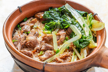 angle view claypot rice with marinated squab at horizontal composition