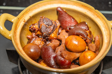 angle view pot of pork knuckles and ginger stew with eggs