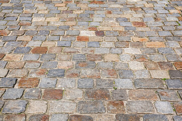 Cobblestone pavement creating a textured surface with warm tones
