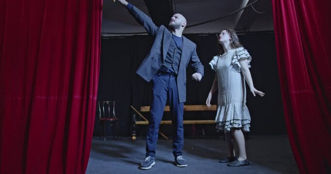 Young actors rehearse a play on a theater stage. They practice their lines and movements with passion and dedication, bringing the story to life.