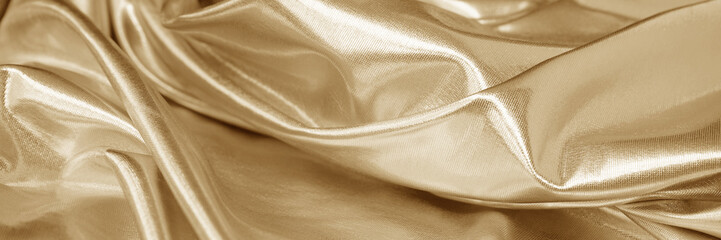 Light soft pale pastel brown gold golden champagne beige white abstract background. Shiny silk fabric. Curtain drapery. Curved line wave wavy. Metallic shine. Light reflection. Design. Wide banner.
