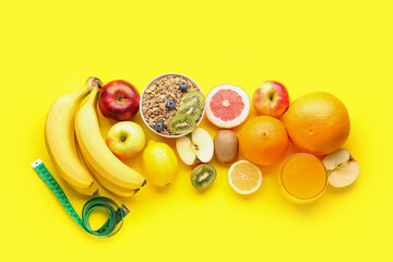Fruits, oatmeal flakes and green measuring tape on yellow background. Diet concept