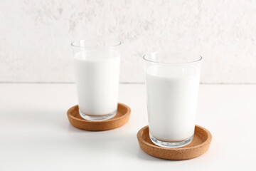 Glasses with fresh milk on white background