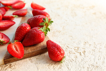 Board with fresh strawberries on white background
