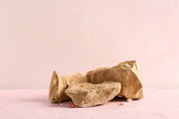 Decorative stone podiums on pink background
