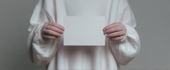Woman In White Sweater Holding Blank White Card