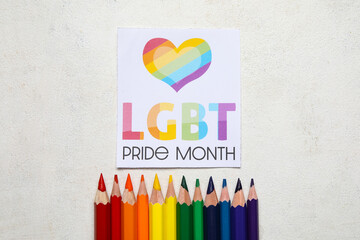 Card with text LGBTQ PRIDE MONTH and pencils on white background
