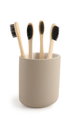 Bamboo tooth brushes in holder on white background