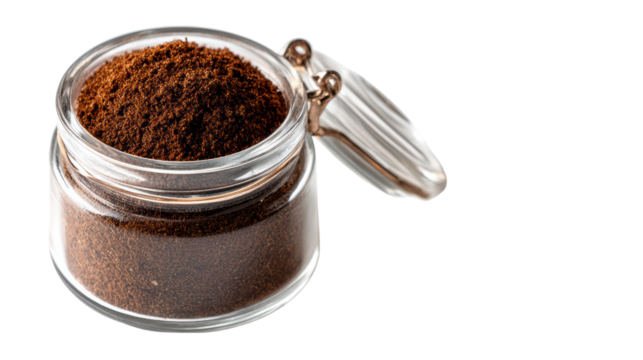Ground coffee in a clear glass jar, isolated on a white background.