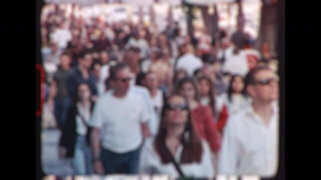 Timelapse of pedestrians and tourists casually strolling along vibrant street during sunny summer day, capturing urban lifestyle and local energy modern city