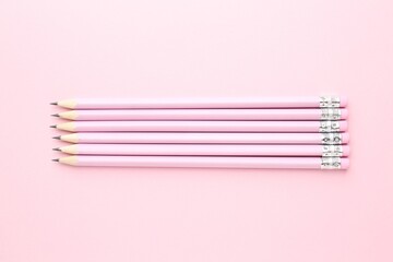 Many graphite pencils on pink background, flat lay