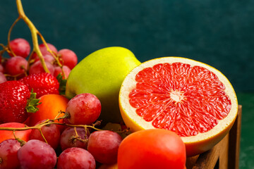 Wooden box with different fresh fruits, closeup
