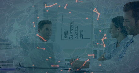 Three professionals wearing business attire analyzing bar chart in office, with network overlay