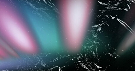 Image of light streaks and shattered glass pattern on dark background