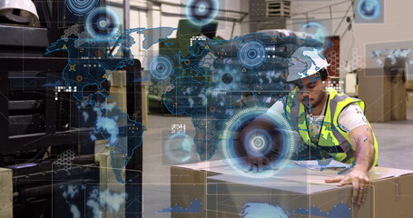 Reaching male wearing helmet and vest handling cardboard box in warehouse, with overlay, copy space