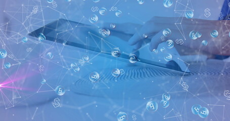 Touching tablet screen while viewing floating Bitcoin and dollar symbols on Zen garden tabletop