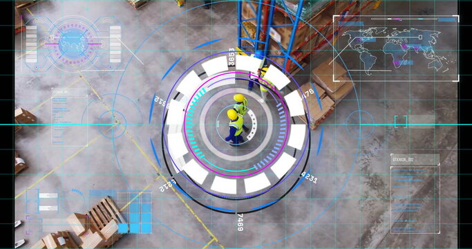 Monitoring two workers wearing yellow hard hats using holographic interface at warehouse with racks