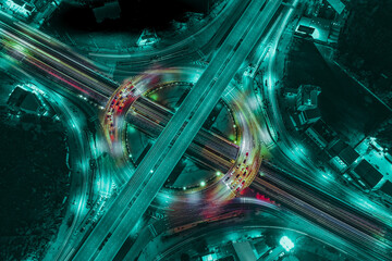 Morden city and smart transportation with Expressway, Road and Roundabout, busy highway traffic night time. Important infrastructure.	