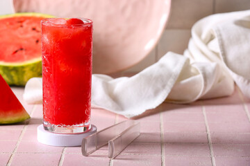 Glass of tasty watermelon fresh on pink tile background