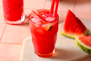 Glass of tasty watermelon fresh on beige tile background