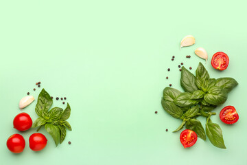 Fresh basil, cherry tomatoes and peppercorn on green background