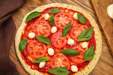 Tasty pizza on wooden background