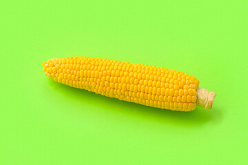 Fresh corn cob on green background