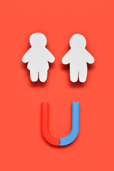 Couple made of paper with magnet on red background