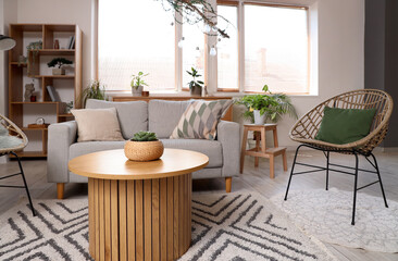 Comfortable armchair, sofa and table in living room