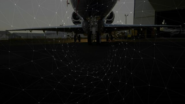 Network spiraling vortex then receding to reveal jet nose while crew attaching gear for maintenance