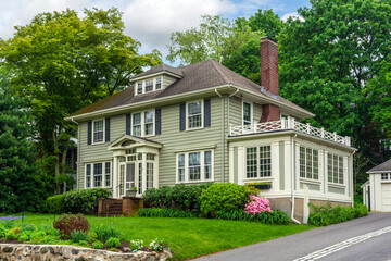 Stylish two-story house with sunroom and manicured front yard garden in Newton, Massachusetts, USA
