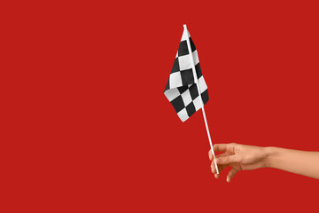 Woman with racing flag on red background