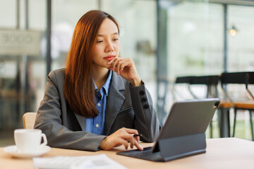Asian female professional executives experts discussing financial accounting papers working workplace office.
