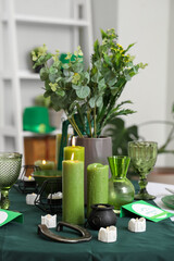Festive table serving with candles in dining room, closeup. St. Patrick's Day celebration
