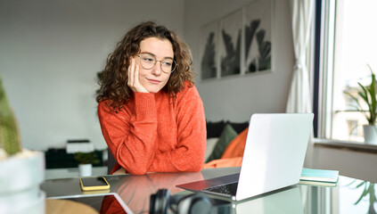 Young woman student or freelancer studying online using laptop elearning or remote working at home...