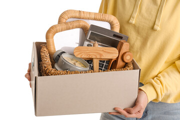 Woman holding box of unwanted stuff for yard sale on white background