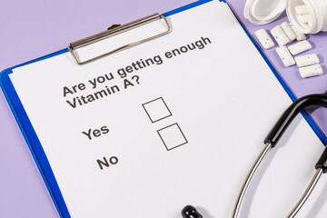 A health questionnaire note questioning the adequacy of vitamin A levels rests with a stethoscope,...