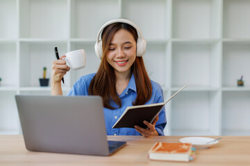 Smiling girl student wear headphone study online with teacher, happy asian woman learn language...
