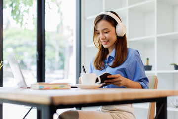 Smiling girl student wear headphone study online with teacher, happy asian woman learn language...
