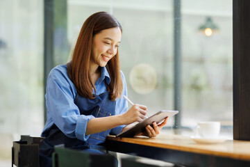 Asian woman, tablet and small business in ecommerce, fashion or logistics in remote startup at...
