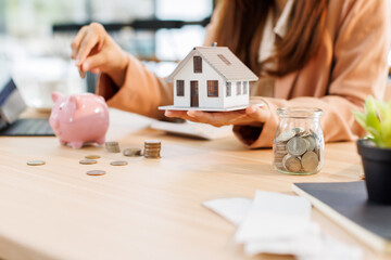 Portrait happy smiling beautiful young asian woman sitting at desk with money and calculator at...
