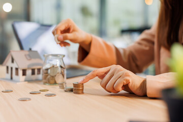 Hand plans home refinance. Pressing calculators, House model, buy or rent, calculators on desk....