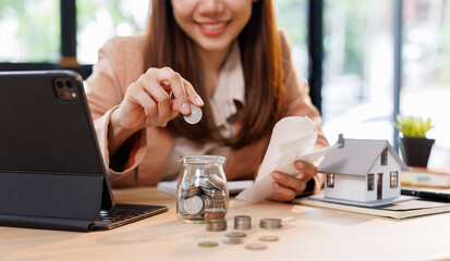 Hand plans home refinance. Pressing calculators, House model, buy or rent, calculators on desk....