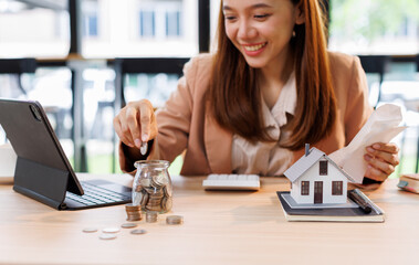 Hand plans home refinance. Pressing calculators, House model, buy or rent, calculators on desk....