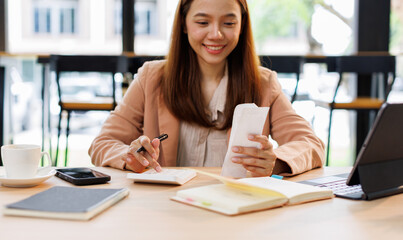 Young woman holding bills working for calculate business data, taxes, bills payment, Start up...