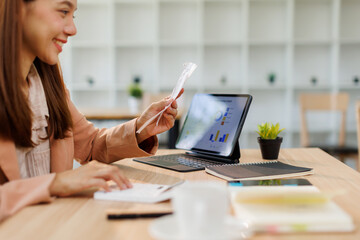 Young woman holding bills working for calculate business data, taxes, bills payment, Start up counting finance. accounting, statistics, and analytic research concept 