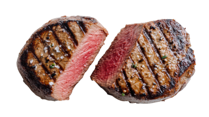 Grilled steak cut in half, revealing juicy pink interior and charred markings, isolated on white background.