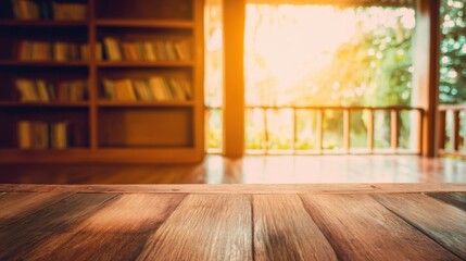 Obraz premium Serene indoor-outdoor scene with rustic wooden table, bookshelf filled with orderly books, soft golden sunlight streaming through large window, and lush greenery outside.